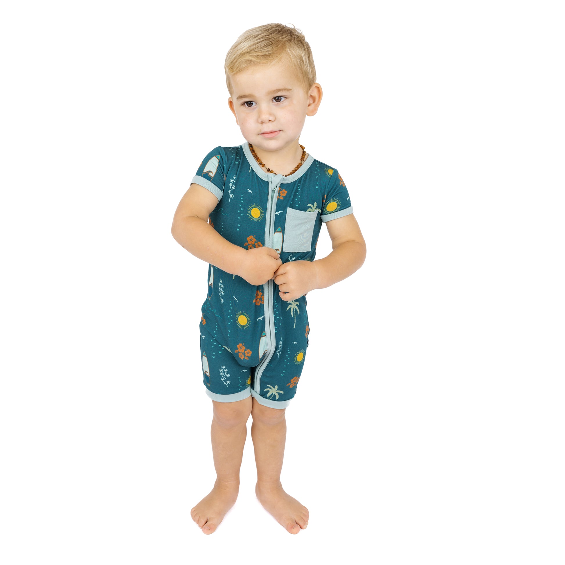 Baby wearing Surf’s Up bamboo shortie romper standing