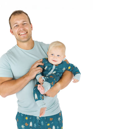 Father holding baby wearing Surf’s Up bamboo pajamas