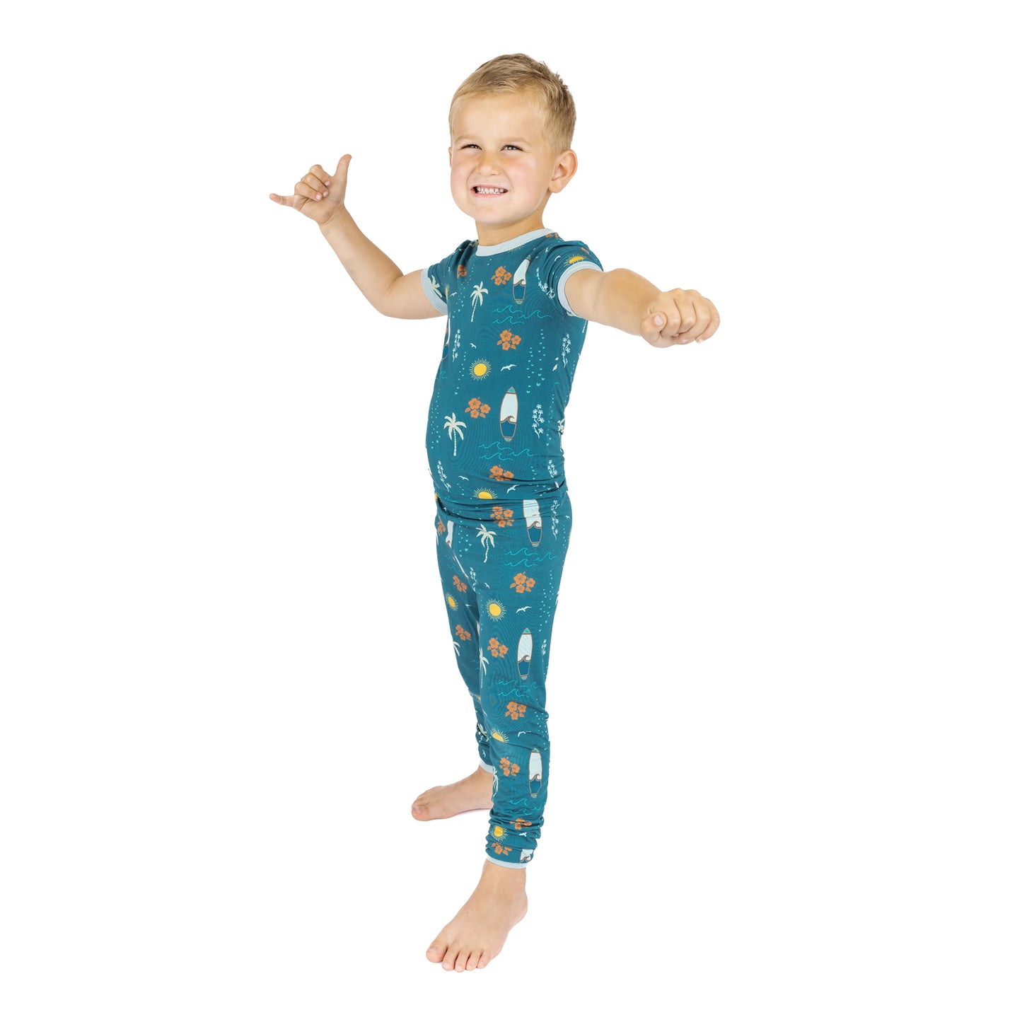 Child wearing Surf’s Up bamboo pajamas full body view