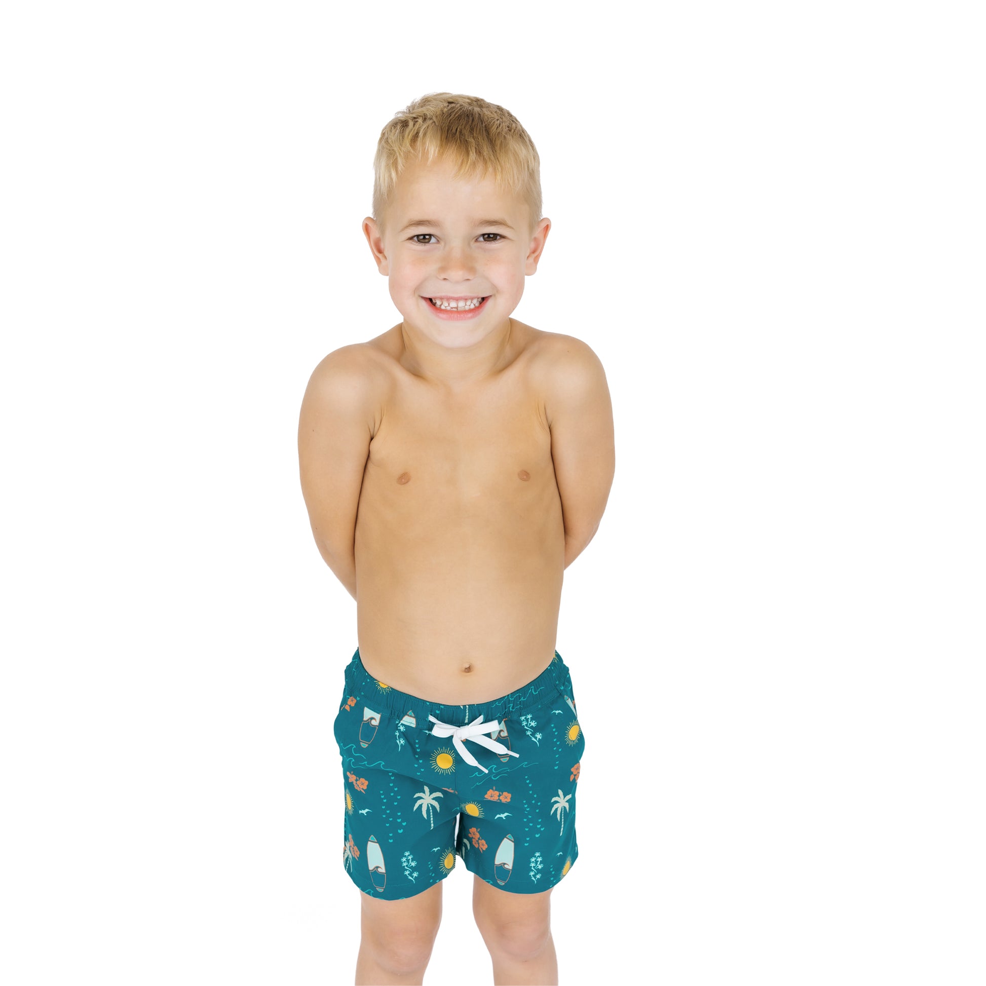 Child wearing Surf’s Up swim trunks standing