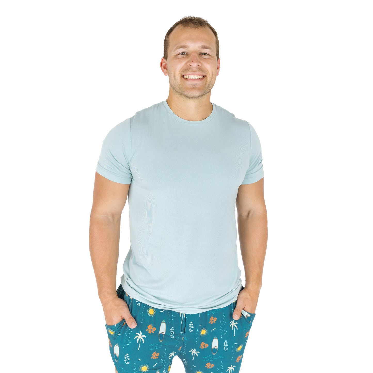 Man wearing Surf’s Up bamboo pajama pants with light blue shirt