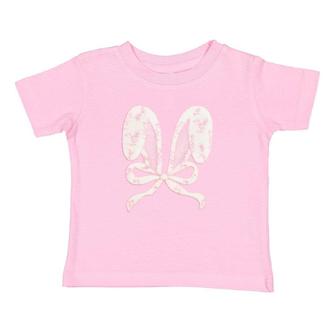 Pink t-shirt with white floral butterfly design on a white background