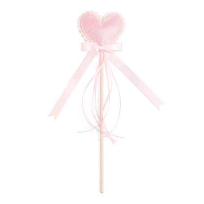 Pink heart-shaped wand with ribbons on a white background
