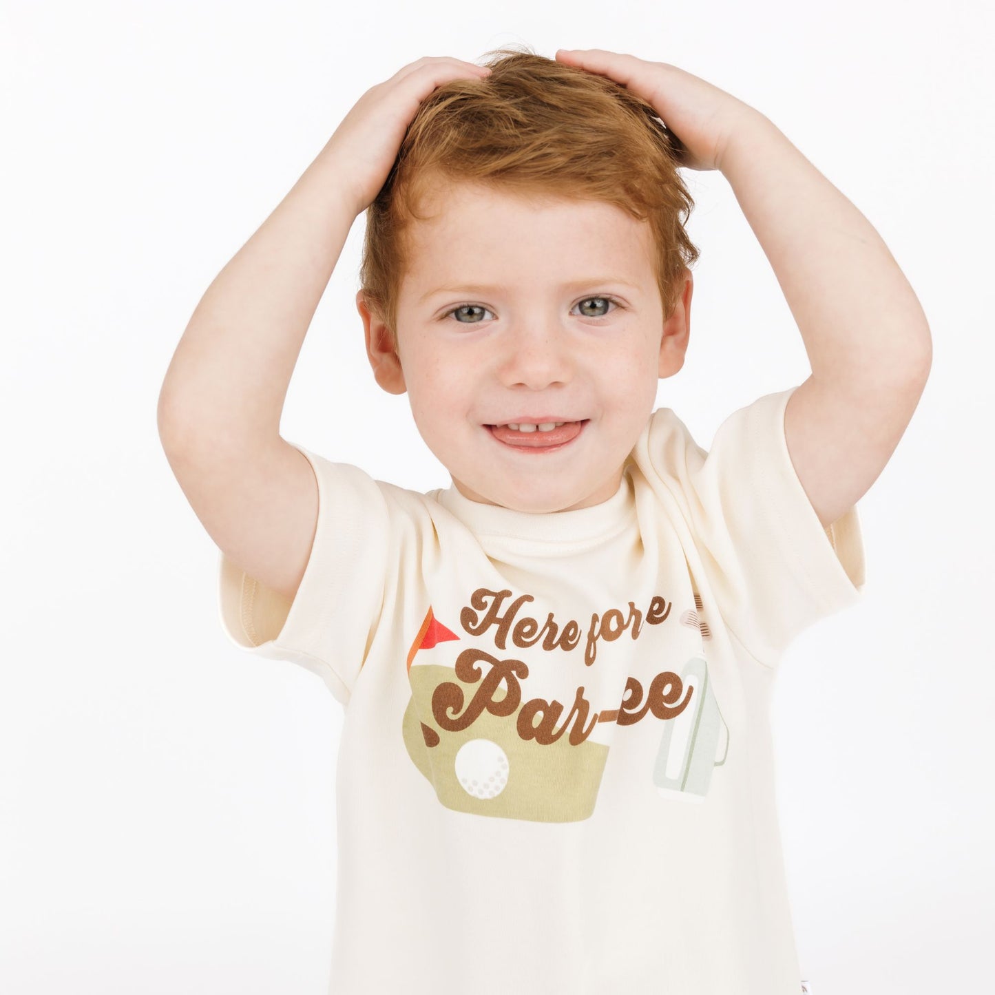 Child wearing a white t-shirt with text on a plain background