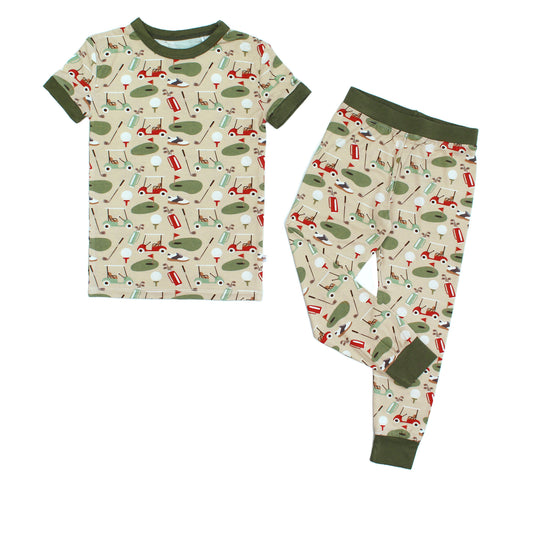 Children's pajama set with golf-themed pattern on a white background