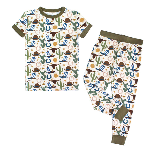 Our Western Howdy Collection! This cozy bamboo 2-piece pajama features a charming cowboy-themed print with blue boots, cacti, suns, horseshoes, and cowboy hats. 