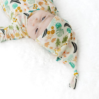 Close-up of a newborn in the Tropical Blooms tie-gown, highlighting the gentle, moisture-wicking fabric for sensitive skin.