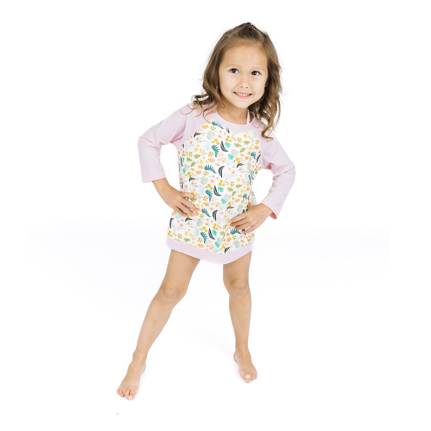 Full-length view of a child wearing the Tropical Blooms baseball-style swim shirt, which blocks 98% of harmful UV rays.