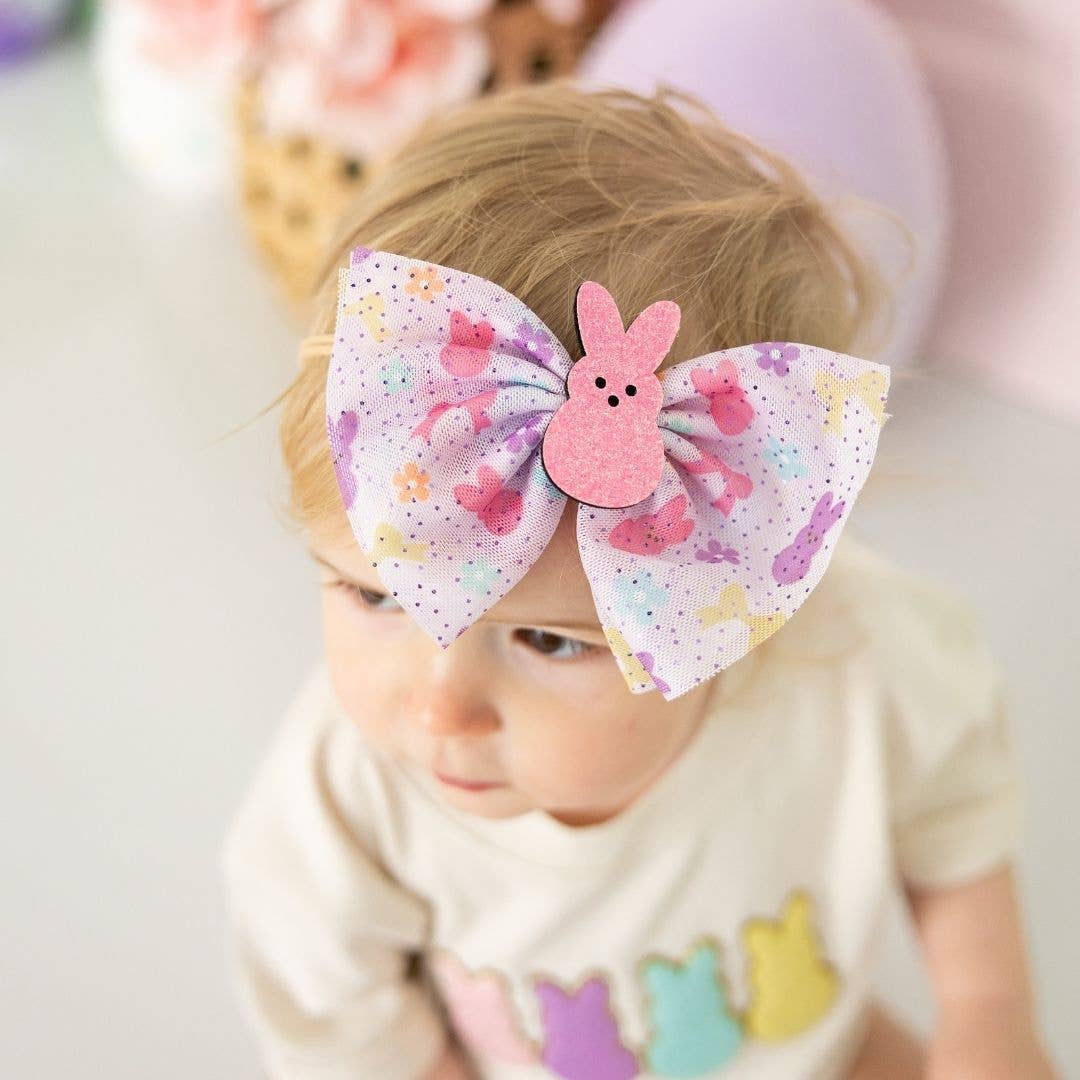 little girl wearing easter bunny themed headband with a bunny in the middle