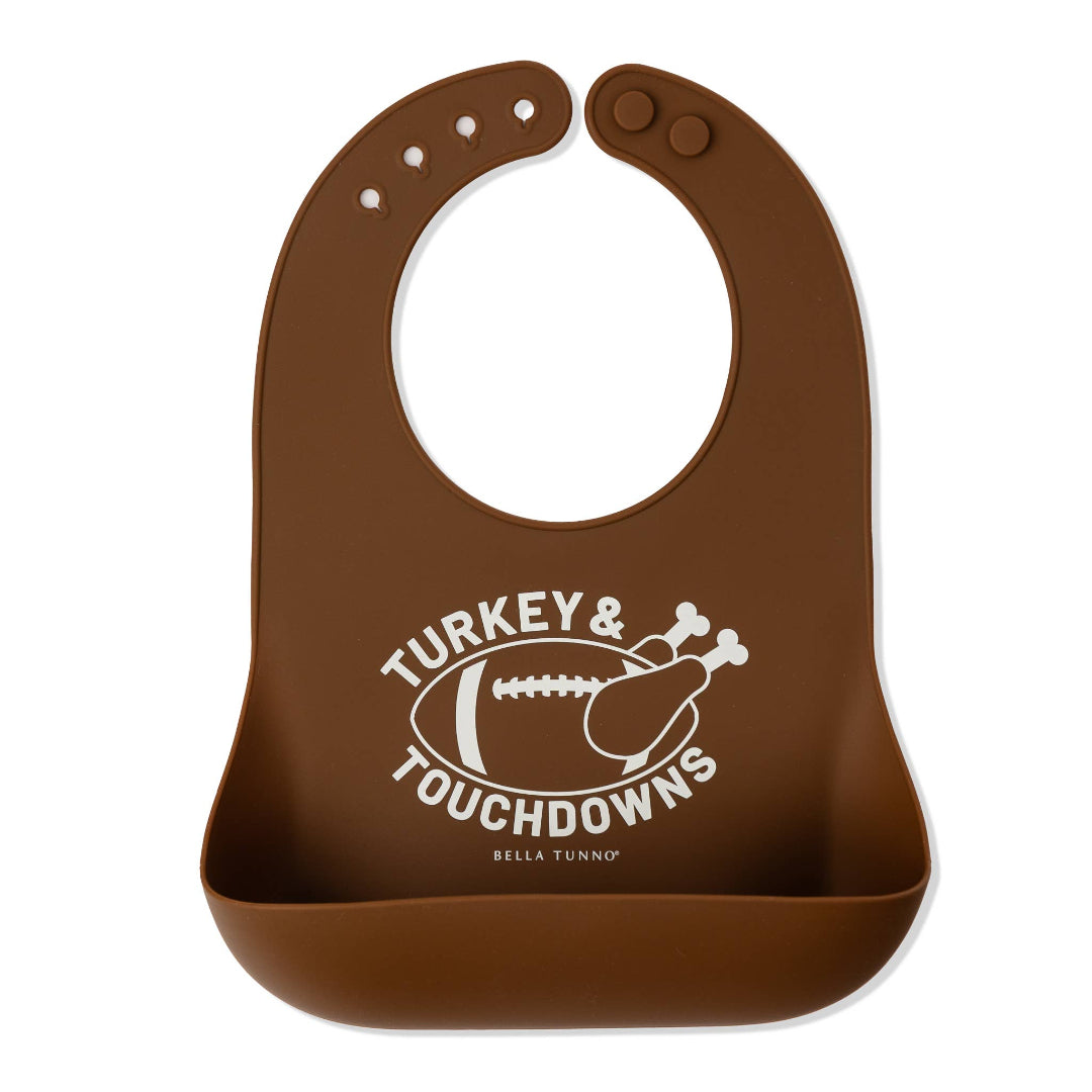 Brown silicone bib that says turkey and touchdowns