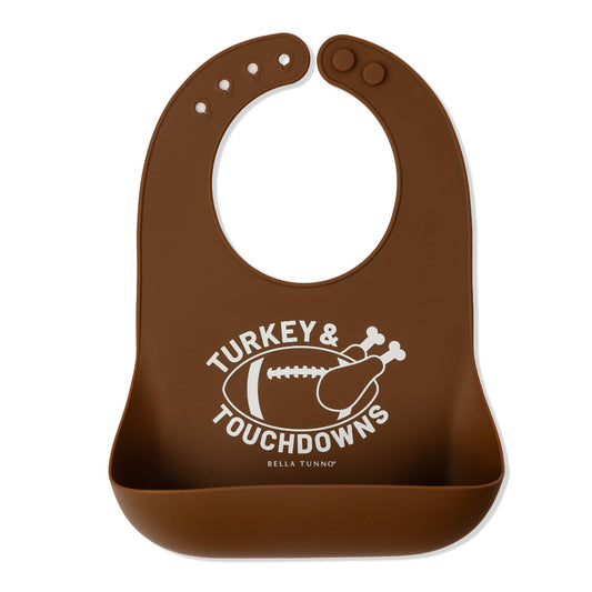 Brown silicone bib that says turkey and touchdowns