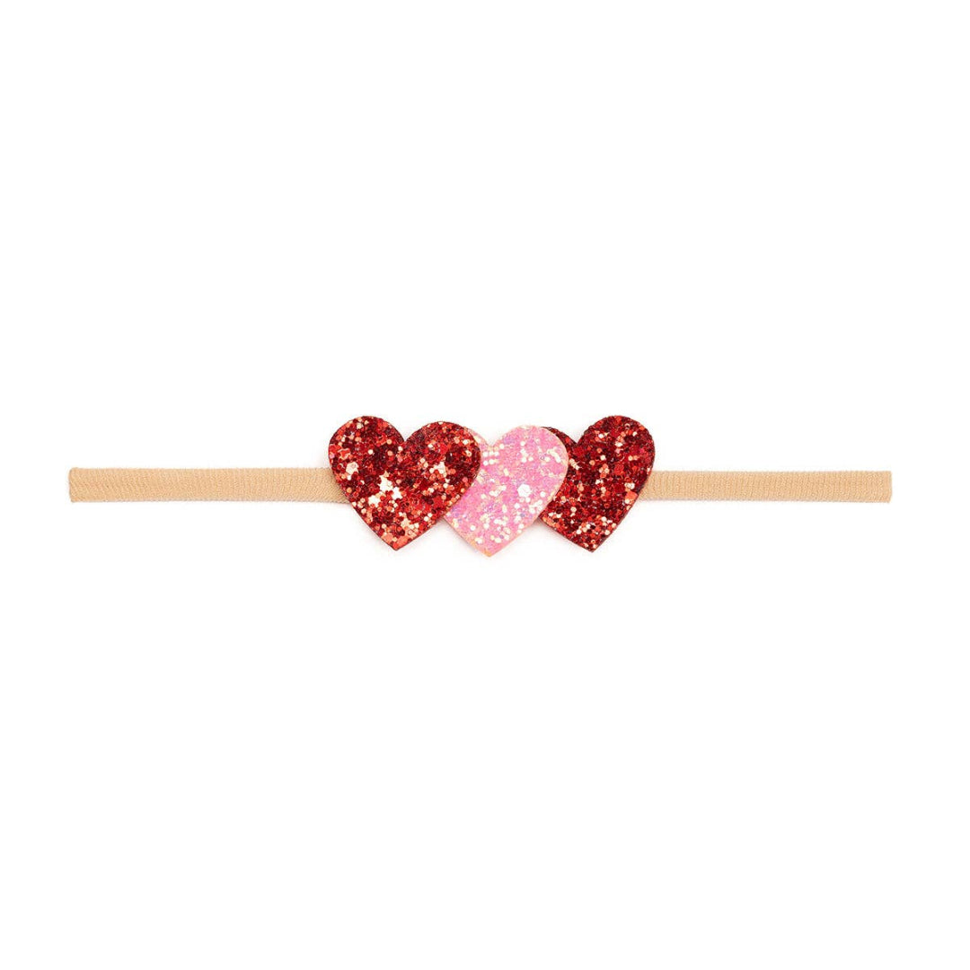 headband with 3 glittery hearts on the front in pink and red