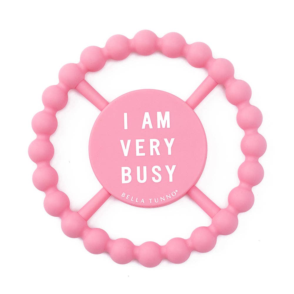 Pink beaded teether with 'I AM VERY BUSY' text on a white background