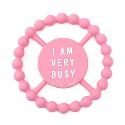 Pink beaded teether with 'I AM VERY BUSY' text on a white background