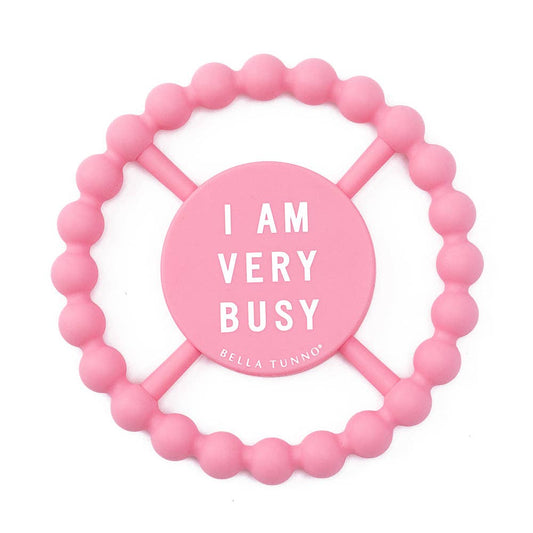 Pink beaded teether with 'I AM VERY BUSY' text on a white background