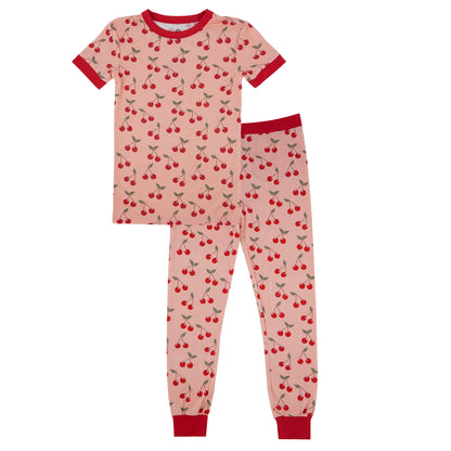 Children's pajama set with cherry pattern on a white background