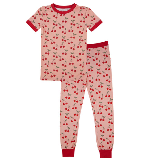 Children's pajama set with cherry pattern on a white background