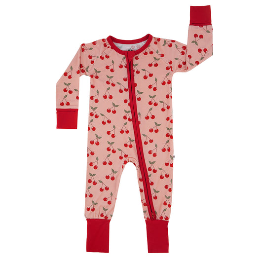 Children's onesie with cherry pattern on a white background