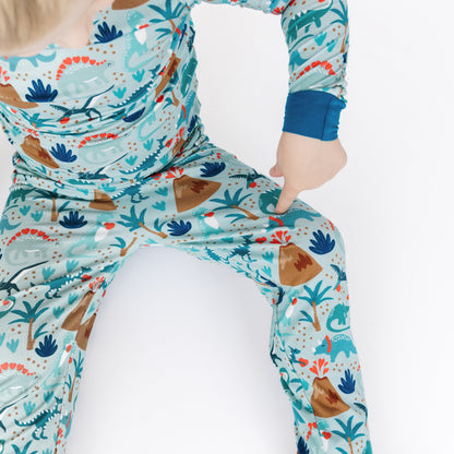 Close-up of volcano dinosaurs print on kids bamboo pajamas.