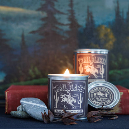Candle labeled 'Trailblazer' with a scenic background