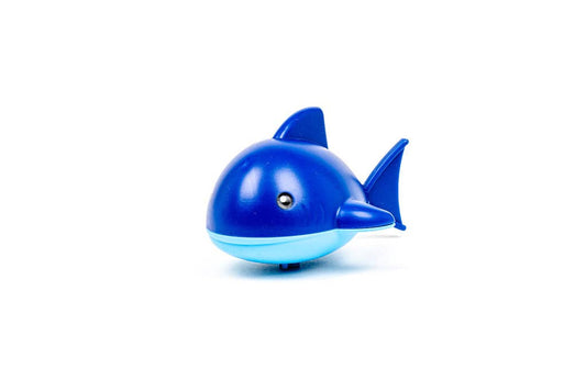 • Blue smiling wind up shark bath toy crawling on flat surface
