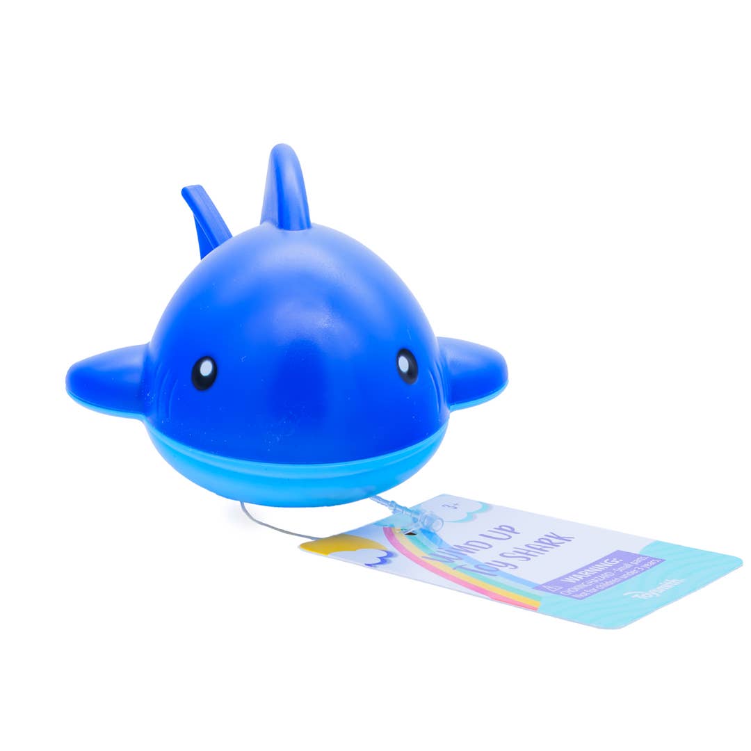 Blue toy shark with a tag on a white background