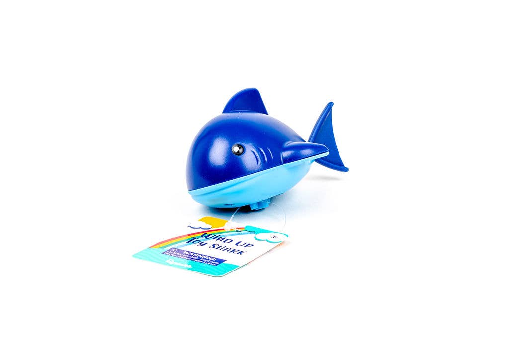Blue whale-shaped toy with a card on a white background