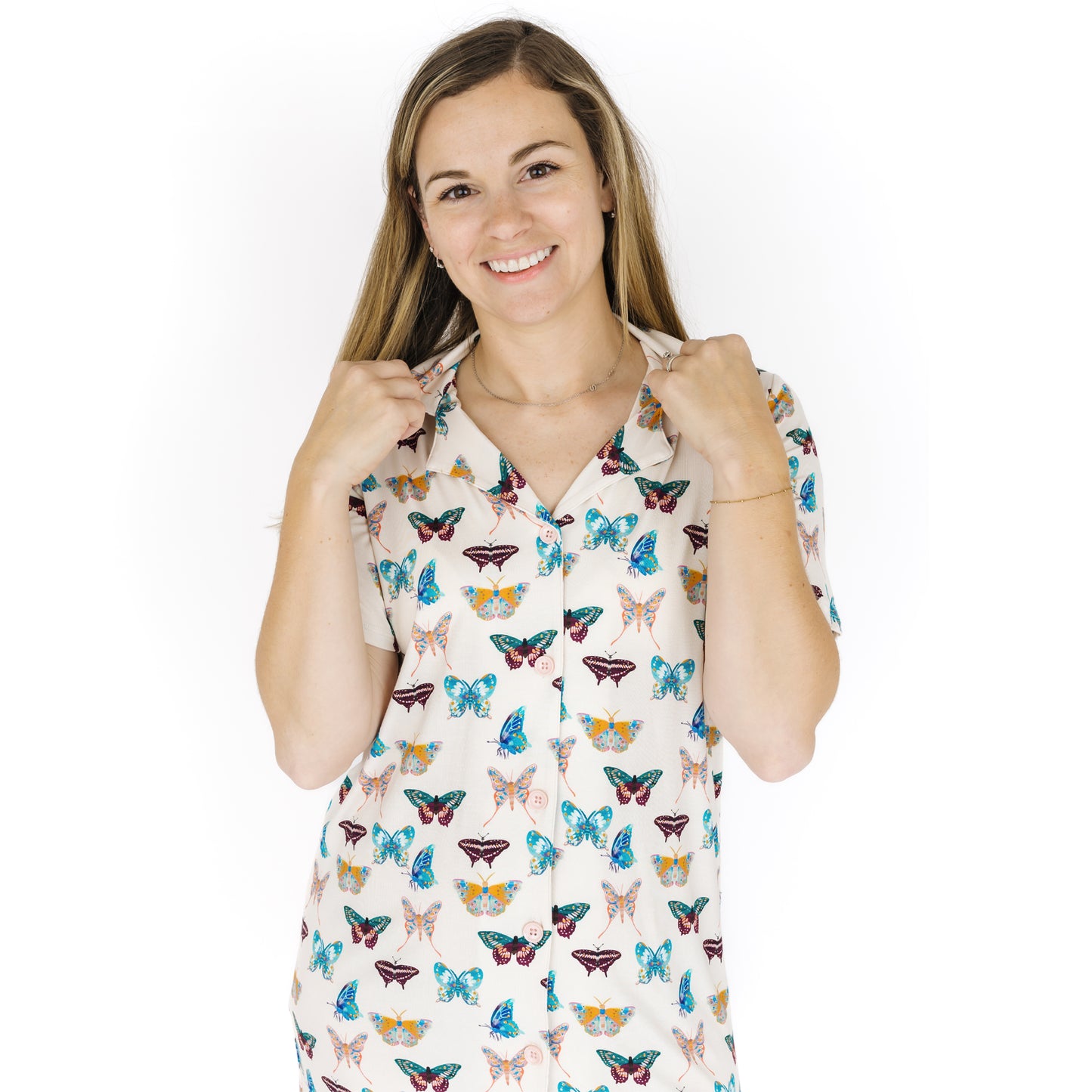 Woman wearing a nightgown with butterfly pattern on a white background