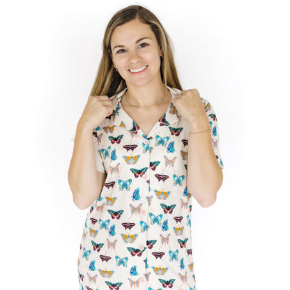 Woman wearing a nightgown with butterfly pattern on a white background