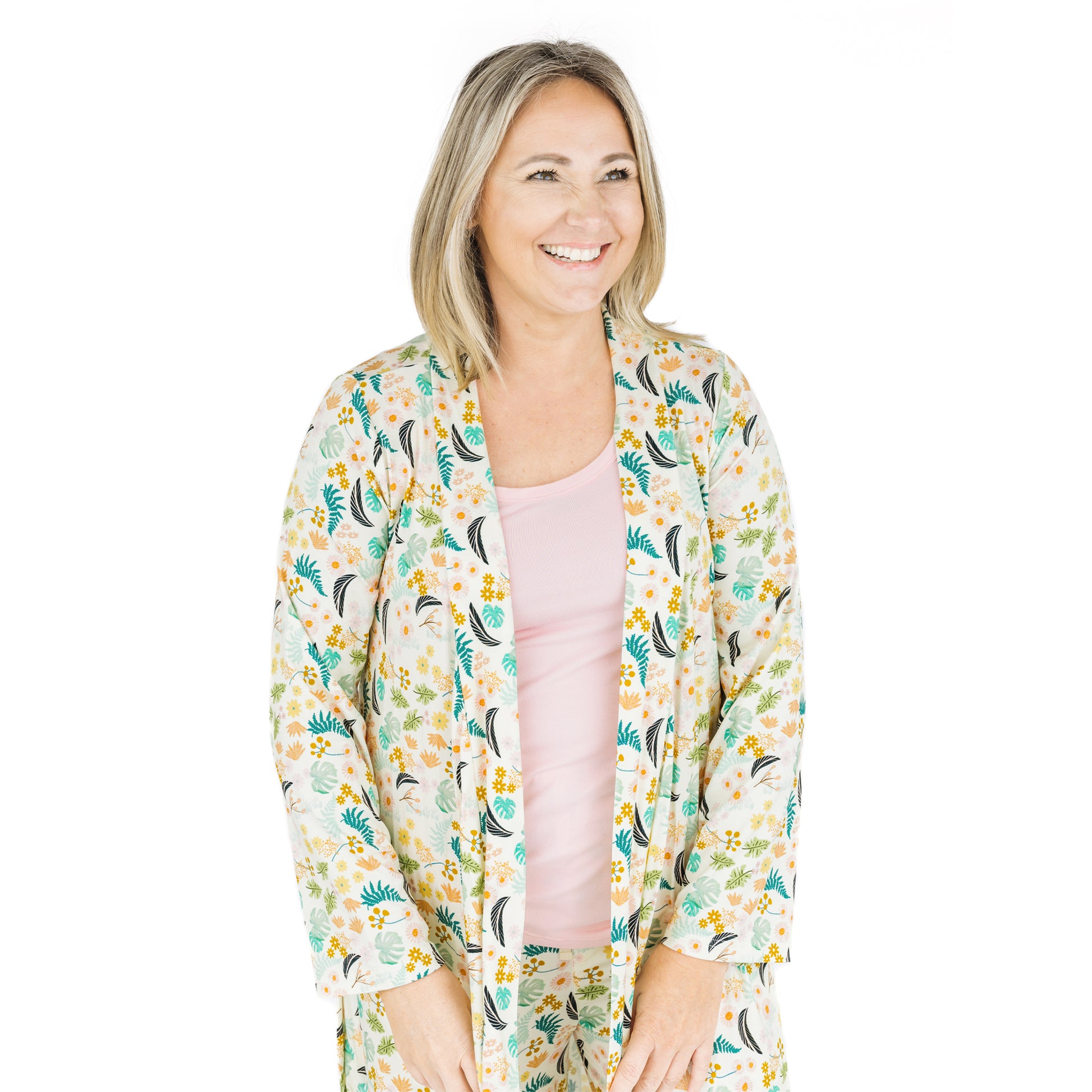 Woman wearing the Tropical Blooms bamboo robe, highlighting the soft ribbed texture and relaxed fit.