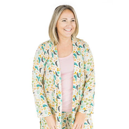 Woman wearing the Tropical Blooms bamboo robe, highlighting the soft ribbed texture and relaxed fit.
