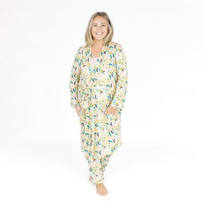 Woman wearing the Tropical Blooms bamboo robe, highlighting the soft ribbed texture and relaxed fit.