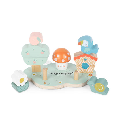 Set of wooden toys including a birdhouse, mushroom, and other items on a white background