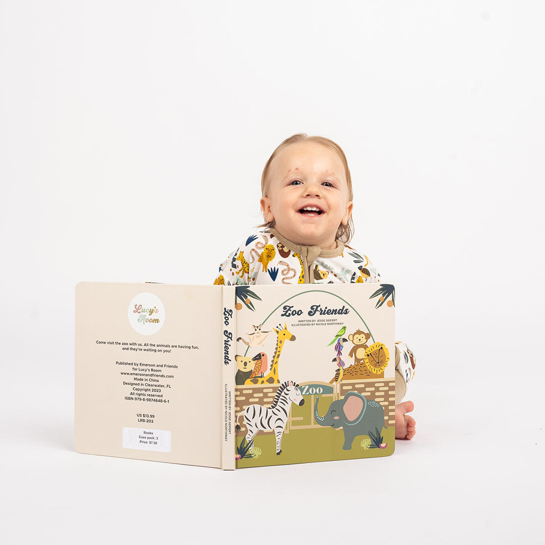 little baby wears the "zoo friends" convertible and reads the "zoo friends" board book. 