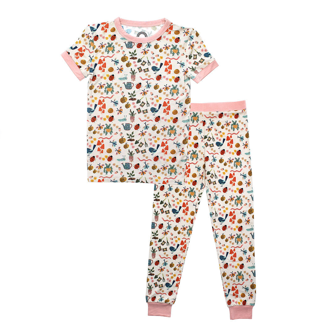 Flat lay 2 set bamboo pajama from the Garden and Friends collection. The print showcase ladybugs, butterflies, flowers, birds, snails, cactus, bees and plants. 