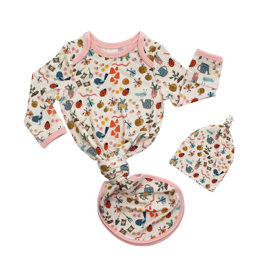 Flay lay gown on white background. Showcasing our Garden and Friends print. The print showcase ladybugs, butterflies, flowers, birds, snails, cactus, bees and plants. 
