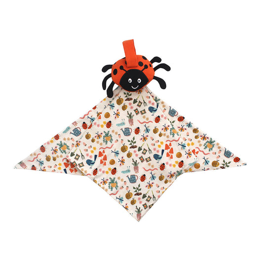 Flat lay ladybug lovey on a white background. 