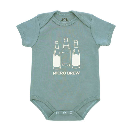 A short-sleeve baby bodysuit in dusty sage green with a white graphic of three beer bottles and the text 'MICRO BREW' printed on the chest, displayed flat against a white background.